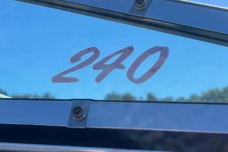 Slide: The Image of Reinell 240 boat window with model number, 1997, against clear blue sky. - 4