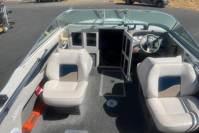 Slide: The Image of 1997 Reinell 240 boat interior with dual seats and steering console. - 7