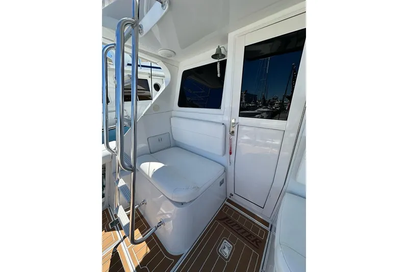 Slide: The Image of Interior of 2001 Jupiter 35 Convertible boat with white seating and sleek design. - 11