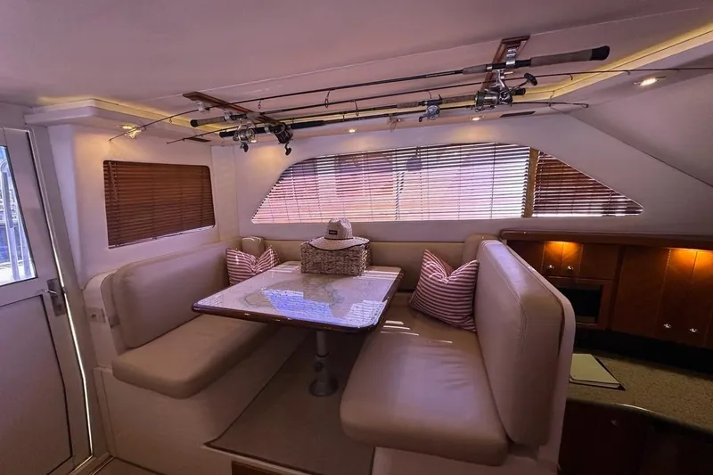 Slide: The Image of Luxurious interior of 2001 Jupiter 35 Convertible yacht with dining area and fishing rods. - 14
