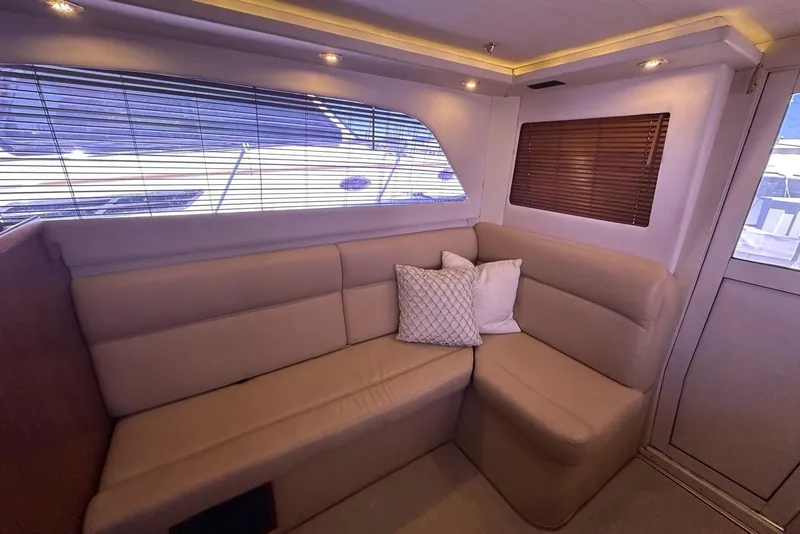 Slide: The Image of Luxurious interior of 2001 Jupiter 35 Convertible yacht with beige seating and decorative pillows. - 16