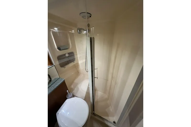 Slide: The Image of Bathroom interior of 2001 Jupiter 35 Convertible yacht, featuring shower and toilet. - 19