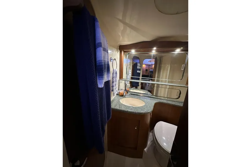 Slide: The Image of Luxurious bathroom in 2001 Jupiter 35 Convertible yacht with modern fixtures and elegant design. - 20