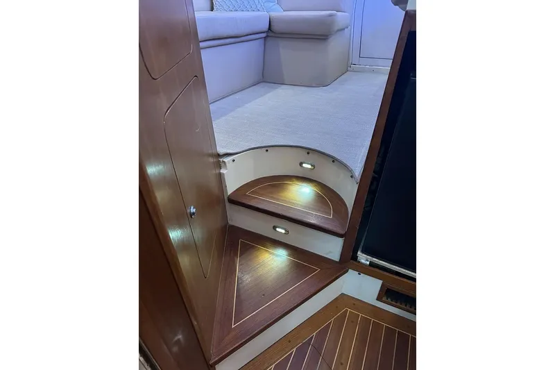 Slide: The Image of Interior of 2001 Jupiter 35 Convertible yacht with wooden steps and carpeted seating area. - 24