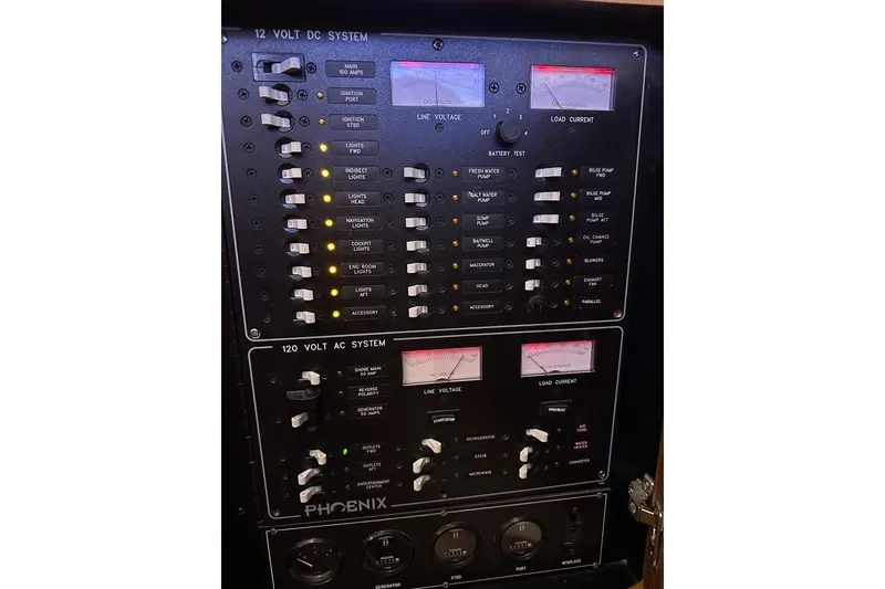 Slide: The Image of Electrical control panel on a 2001 Jupiter 35 Convertible boat, featuring 12V DC and 120V AC systems. - 25