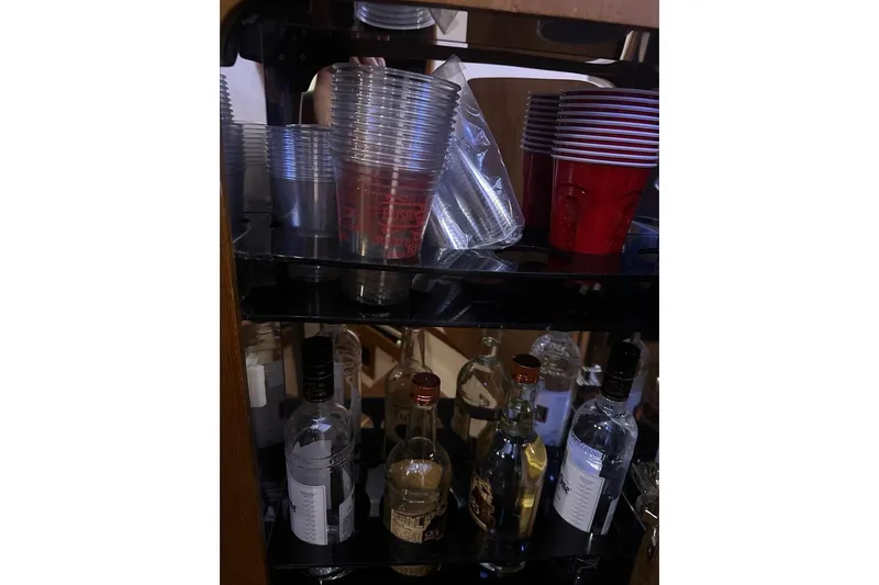 Slide: The Image of Plastic cups and assorted liquor bottles on a shelf, Jupiter 35 Convertible, 2001. - 26