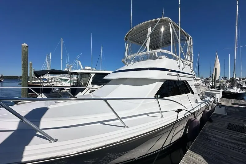 Slide: The Image of 2001 Jupiter 35 Convertible yacht docked at marina under clear blue sky. - 3