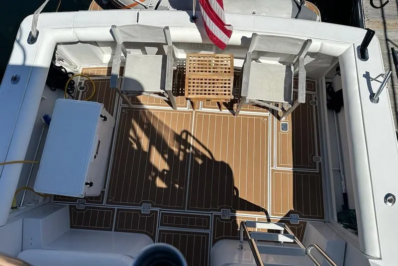 Slide: The Image of Deck of 2001 Jupiter 35 Convertible boat with chairs and American flag. - 41