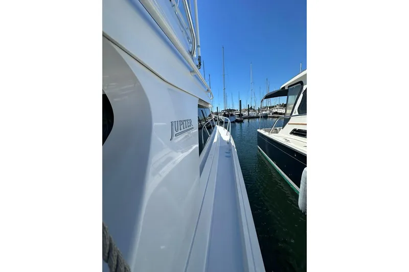 Slide: The Image of 2001 Jupiter 35 Convertible yacht docked at marina, side view. - 5