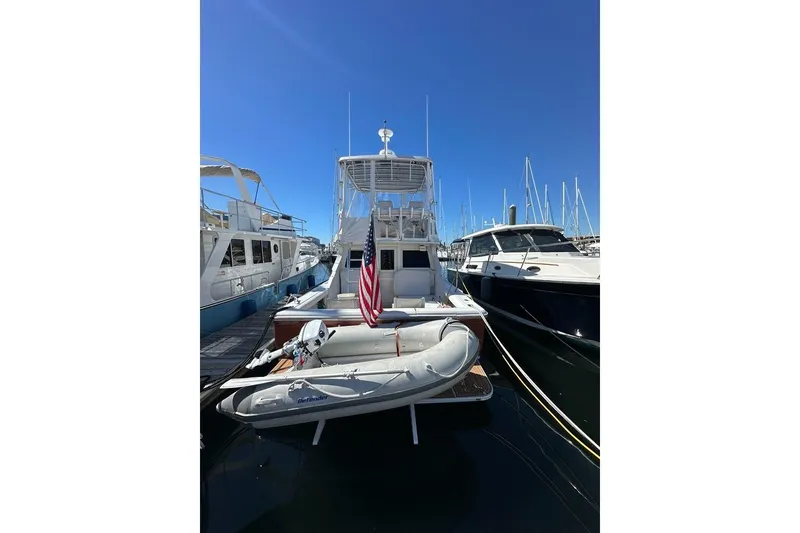 Slide: The Image of 2001 Jupiter 35 Convertible yacht docked with inflatable boat and American flag. - 8
