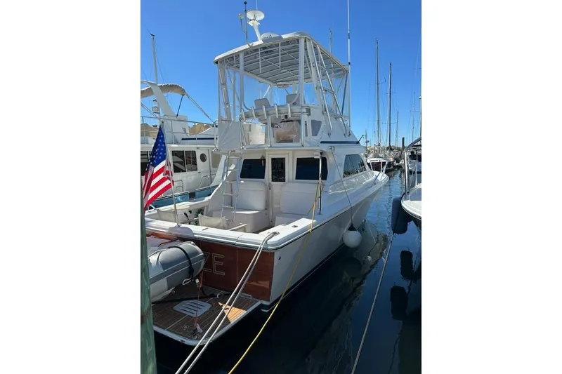 Slide: The Image of 2001 Jupiter 35 Convertible yacht docked at marina with American flag. - 9