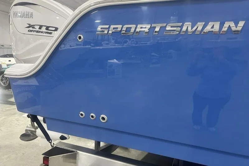 Slide: The Image of 2026 Sportsman Heritage 321 Center Console boat interior with white cushioned seating. - 10