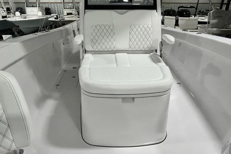 Slide: The Image of 2026 Sportsman Heritage 321 Center Console boat in showroom, blue hull, on trailer. - 11