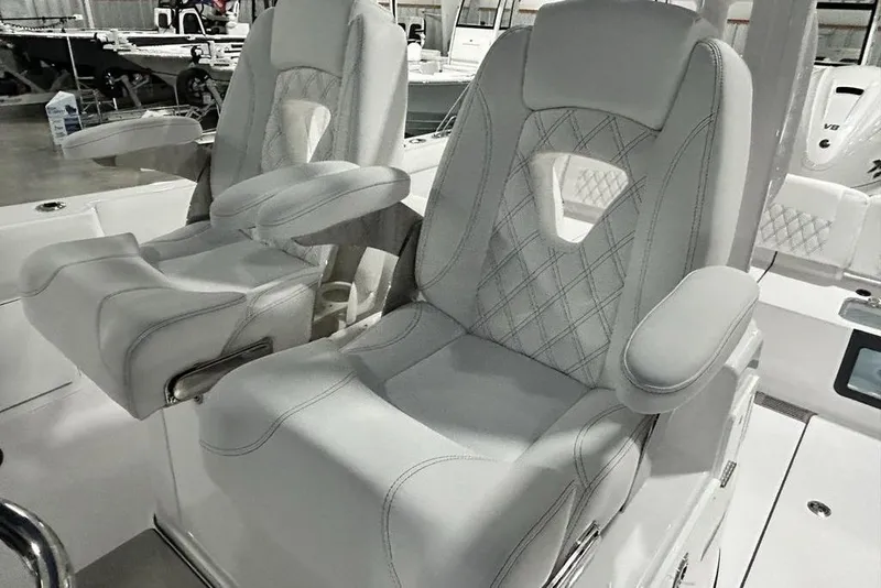 Slide: The Image of 2026 Sportsman Heritage 321 Center Console boat in showroom, featuring Yamaha XTO outboard engines. - 16