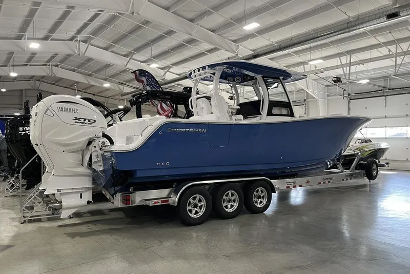 Slide: The Image of 2026 Sportsman Heritage 321 Center Console storage compartment with open hatch and speaker. - 19