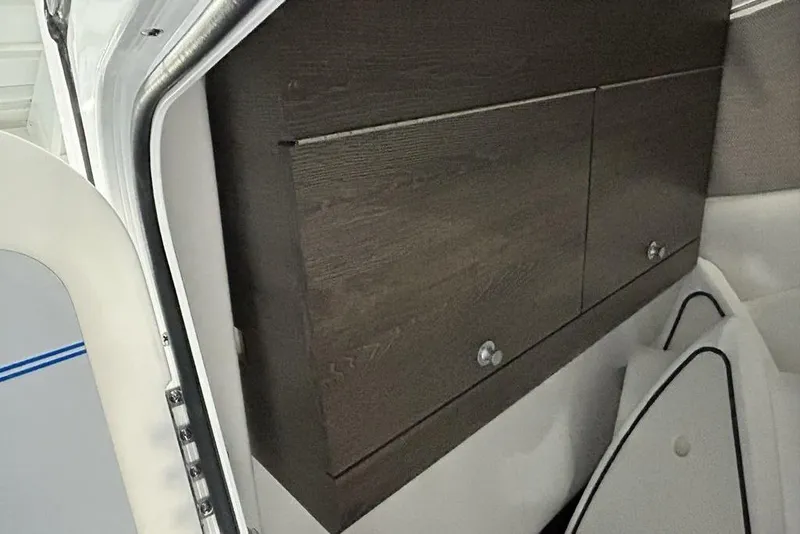 Slide: The Image of 2026 Sportsman Heritage 321 Center Console boat interior with storage and speaker. - 20