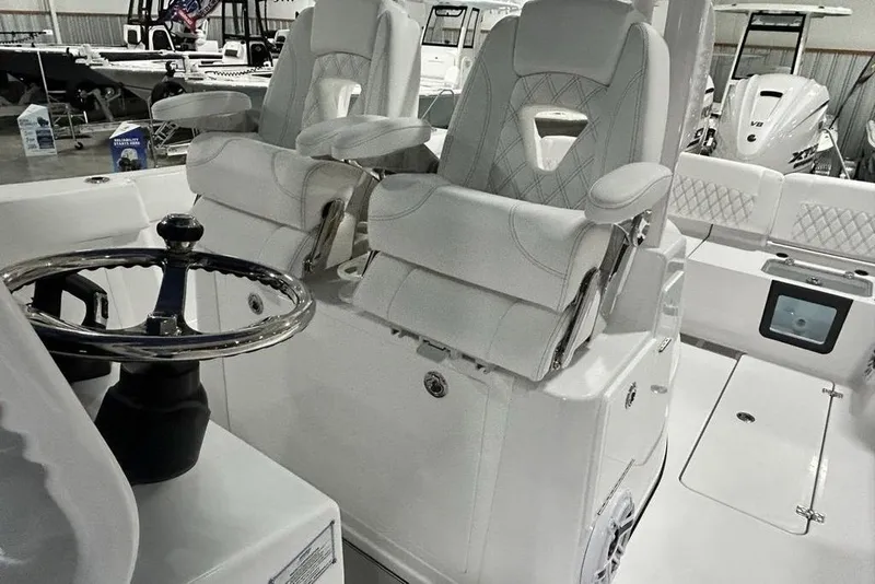 Slide: The Image of 2026 Sportsman Heritage 321 Center Console boat interior with steering wheel and seating. - 25
