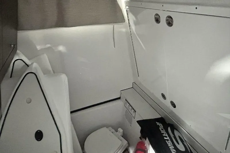 Slide: The Image of 2026 Sportsman Heritage 321 Center Console boat interior in showroom setting. - 26