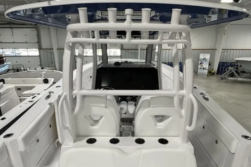 Slide: The Image of 2026 Sportsman Heritage 321 Center Console boat interior with speakers and storage compartment. - 28
