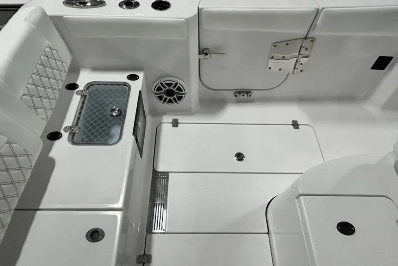 Slide: The Image of 2026 Sportsman Heritage 321 Center Console boat interior with white seating and storage compartments. - 30