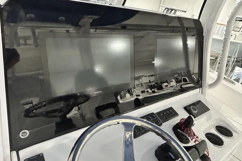 Slide: The Image of 2026 Sportsman Heritage 321 Center Console boat interior with white seating and storage compartments. - 32