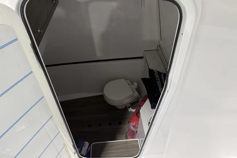 Slide: The Image of Interior view of 2026 Sportsman Heritage 321 Center Console boat's compact bathroom. - 35