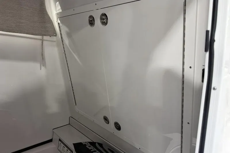 Slide: The Image of Interior view of 2026 Sportsman Heritage 321 Center Console boat, featuring sleek white paneling. - 41