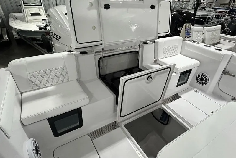 Slide: The Image of 2026 Sportsman Heritage 321 Center Console boat interior with storage compartments and seating. - 46