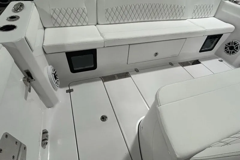 Slide: The Image of 2026 Sportsman Heritage 321 Center Console boat interior with white seating and storage compartments. - 47