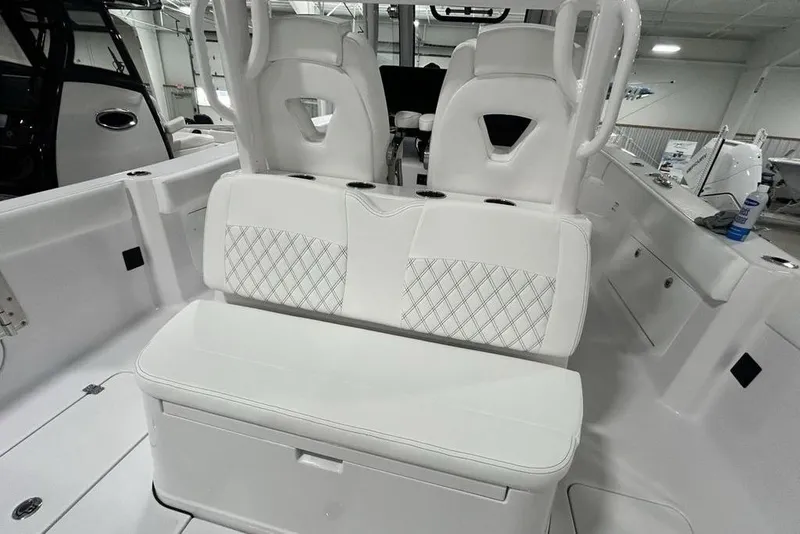 Slide: The Image of 2026 Sportsman Heritage 321 Center Console boat interior with white seating and storage. - 49