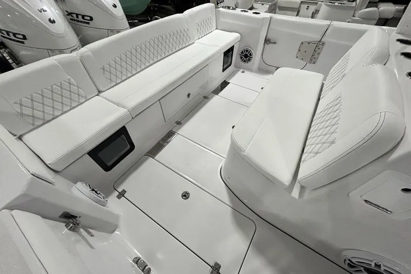 Slide: The Image of 2026 Sportsman Heritage 321 Center Console boat interior with white cushioned seating. - 52