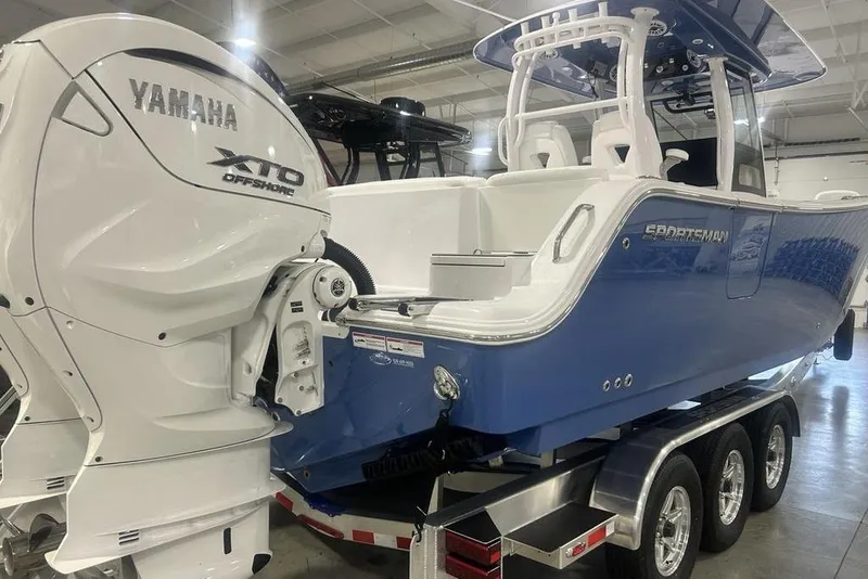 Slide: The Image of 2026 Sportsman Heritage 321 Center Console boat with Yamaha XTO Offshore engine in showroom. - 54