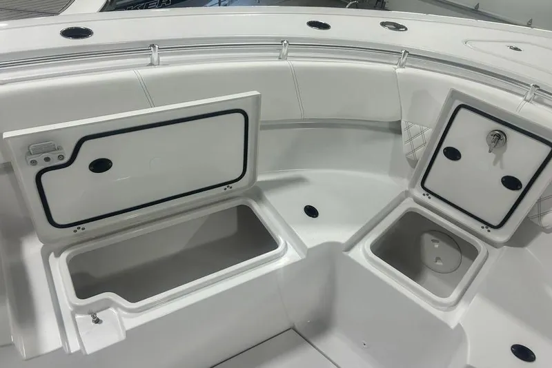 Slide: The Image of 2026 Sportsman Heritage 321 Center Console boat storage compartments open. - 56