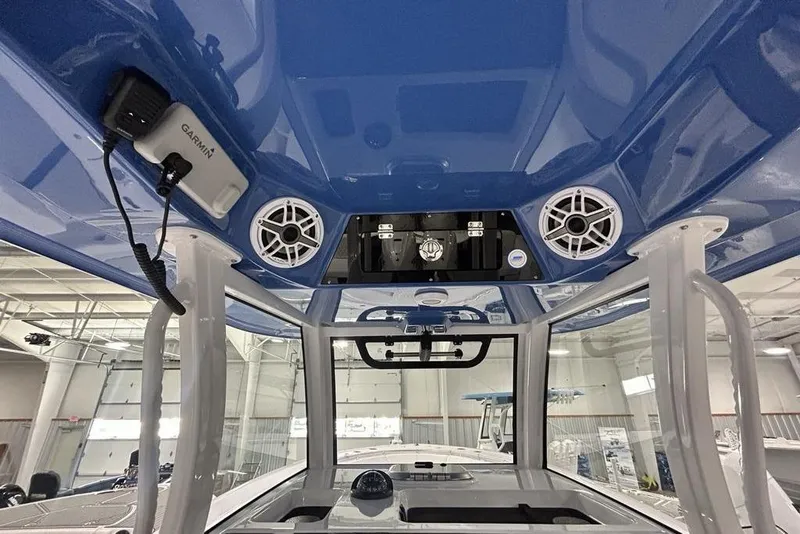 Slide: The Image of 2026 Sportsman Heritage 321 Center Console interior with speakers and Garmin device. - 59