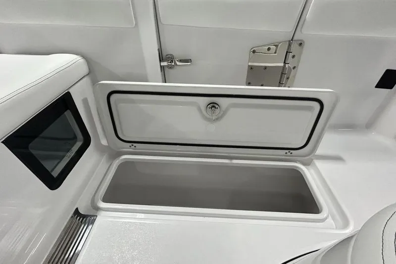 Slide: The Image of 2026 Sportsman Heritage 321 Center Console storage compartment with open hatch and sleek design. - 62