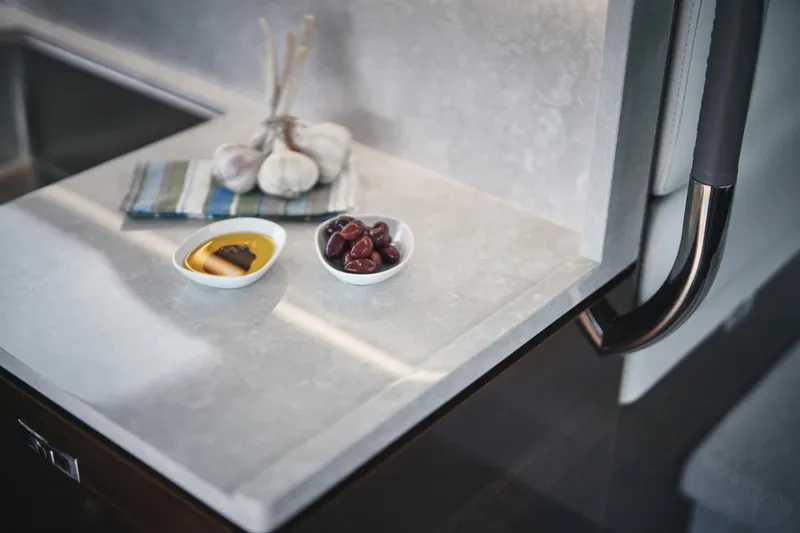 Slide: The Image of Modern kitchen counter on Princess F50 yacht, 2025 model, with snacks and garlic. - 15