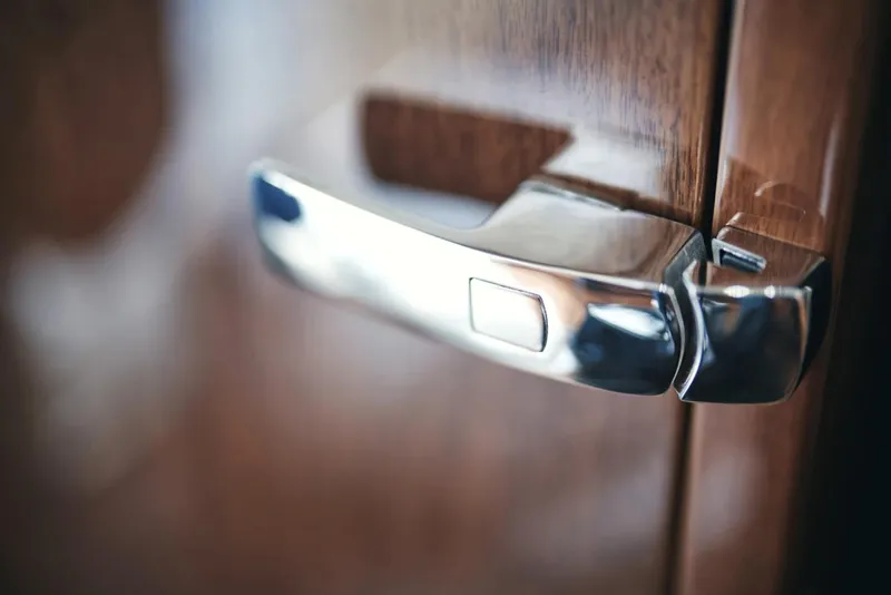 Slide: The Image of Close-up of a sleek chrome door handle on a 2025 Princess F50 yacht. - 16