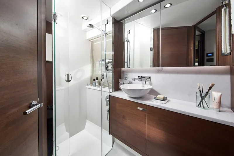 Slide: The Image of Modern bathroom in 2025 Princess F50 yacht with glass shower and wooden cabinets. - 32