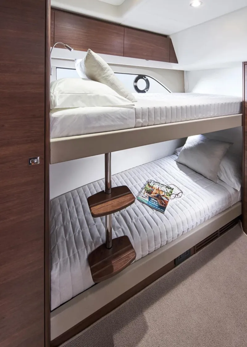 Slide: The Image of Bunk beds in the 2025 Princess F50 yacht cabin with modern wooden finishes. - 33