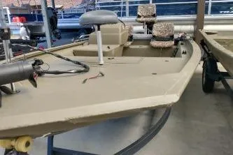 Slide: The Image of 2020 Grizzly 1754 SC boat with camo seats and trolling motor in showroom. - 4
