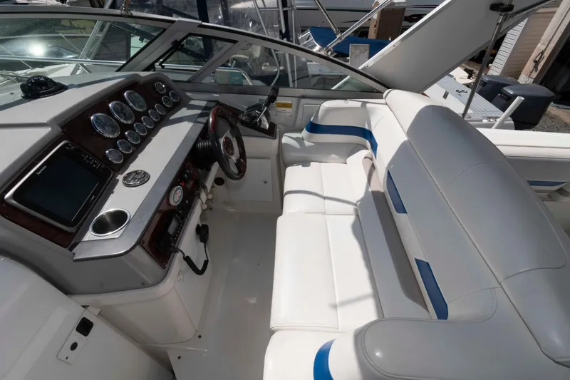 Slide: The Image of 2002 Formula 31 Performance Cruiser cockpit with white seating and modern dashboard controls. - 3