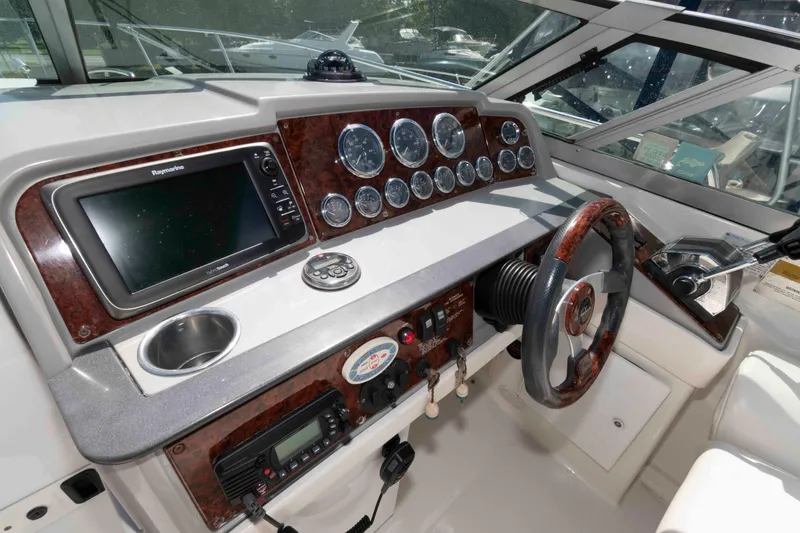 Slide: The Image of 2002 Formula 31 Performance Cruiser helm with gauges, GPS, and wood-trimmed steering wheel. - 4