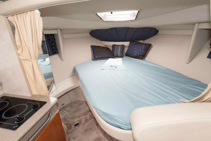 Slide: The Image of 2002 Formula 31 Performance Cruiser interior with cozy bed and compact kitchen area. - 9