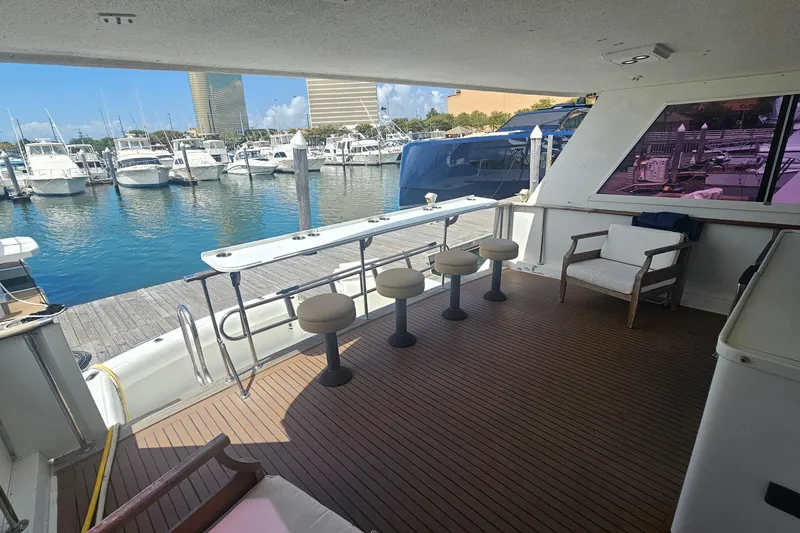 Slide: The Image of Spacious deck of 1990 Hatteras 67 Cockpit Motor Yacht at marina. - 13