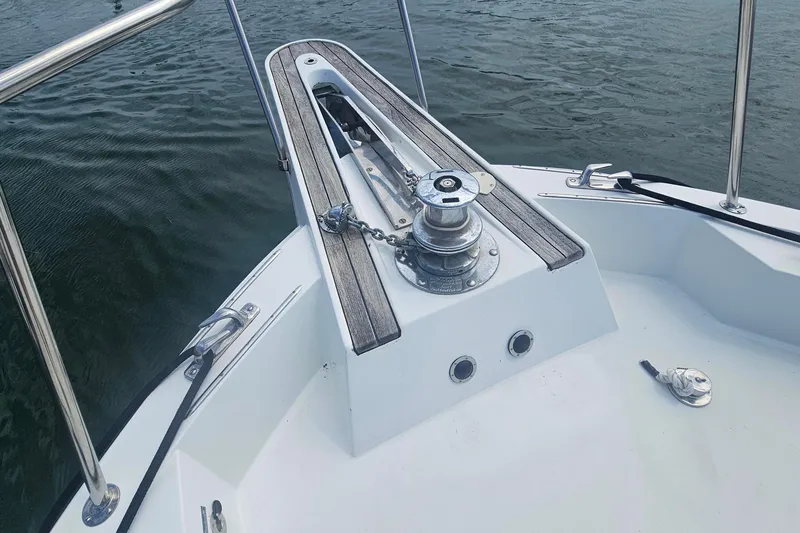 Slide: The Image of Bow of 1990 Hatteras 67 Cockpit Motor Yacht with anchor winch and railing. - 19