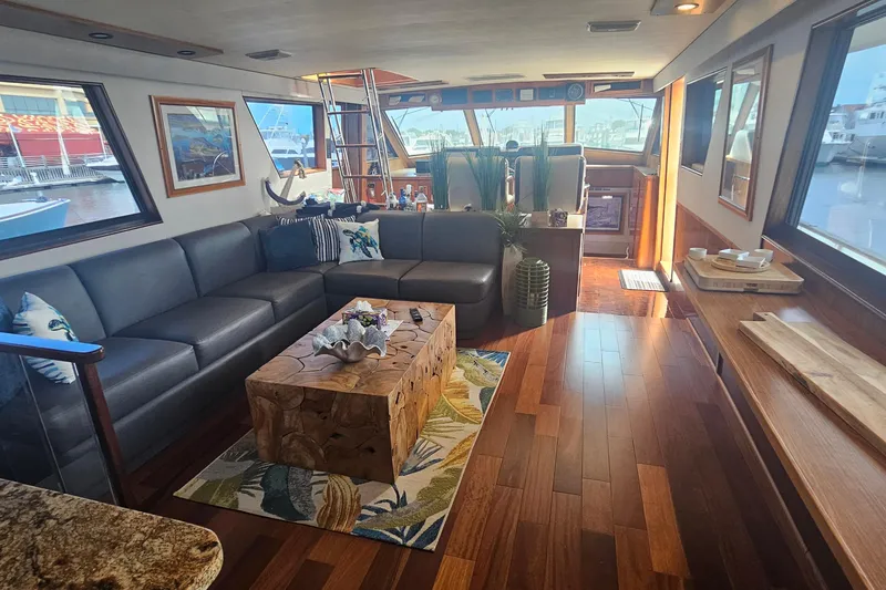 Slide: The Image of Luxurious interior of a 1990 Hatteras 67 Cockpit Motor Yacht with elegant wood flooring. - 21