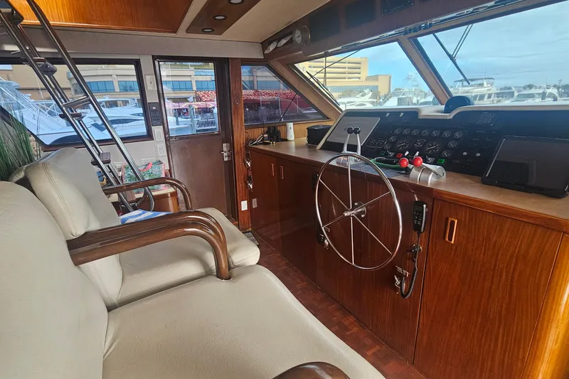 Slide: The Image of Interior of 1990 Hatteras 67 Cockpit Motor Yacht with steering wheel and controls. - 26