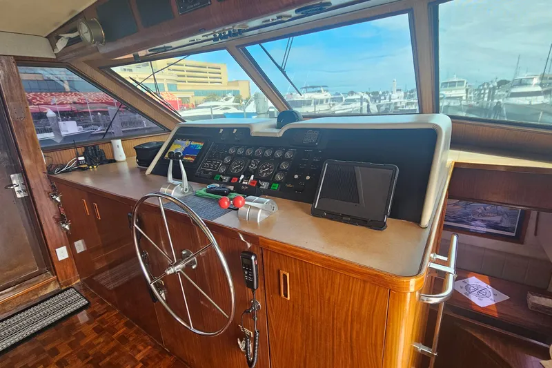 Slide: The Image of Interior helm of 1990 Hatteras 67 Cockpit Motor Yacht with steering wheel and controls. - 27