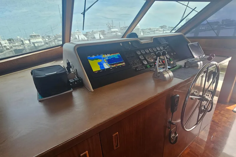 Slide: The Image of Cockpit of 1990 Hatteras 67 Cockpit Motor Yacht with navigation controls and steering wheel. - 30