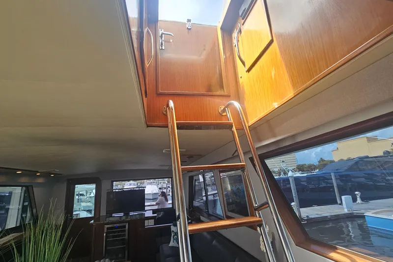 Slide: The Image of Interior view of 1990 Hatteras 67 Cockpit Motor Yacht with ladder to upper deck. - 31